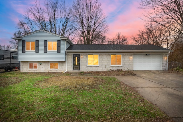 split level home featuring a yard and a garage