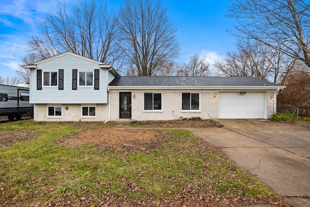 split level home with a garage and a front yard