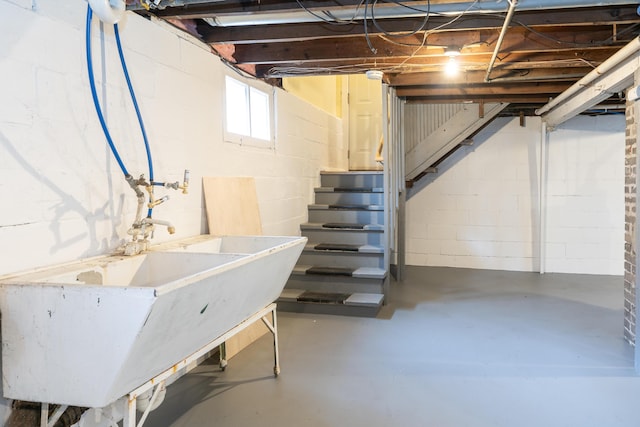 below grade area with stairway and a sink