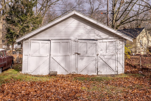 view of shed featuring fence