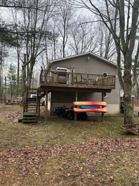 rear view of house featuring a deck