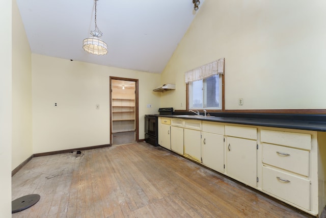 kitchen with black range with electric stovetop, sink, extractor fan, cream cabinetry, and light wood-type flooring