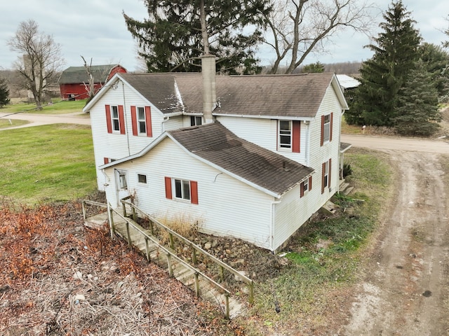 view of side of property with a lawn