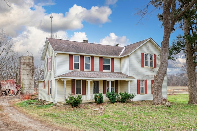 view of front of property with a porch and a front lawn