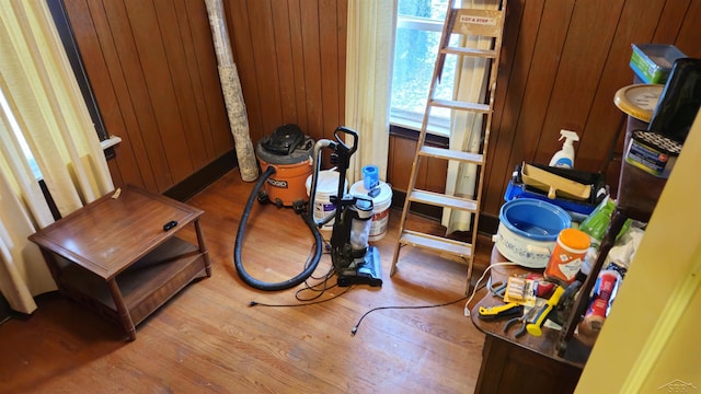 interior space featuring hardwood / wood-style floors and wooden walls