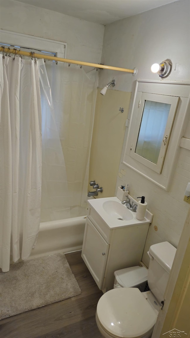 full bathroom with hardwood / wood-style floors, vanity, toilet, and shower / bath combination with curtain