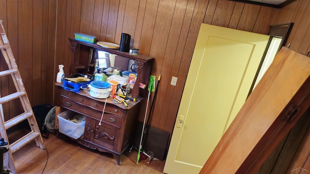 interior details with hardwood / wood-style flooring and wooden walls