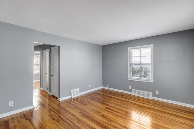 unfurnished room with light wood-type flooring