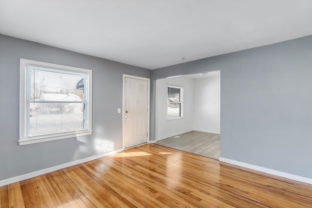 unfurnished room with a wealth of natural light and light hardwood / wood-style flooring