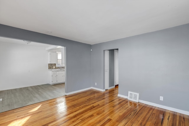 unfurnished living room featuring light wood-type flooring