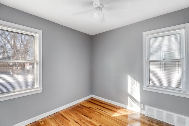 spare room with ceiling fan and wood-type flooring