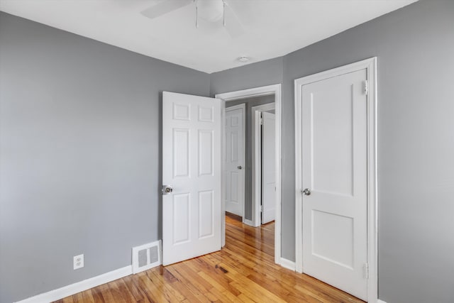 unfurnished bedroom with ceiling fan and light wood-type flooring