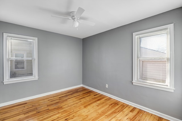 spare room featuring light hardwood / wood-style flooring and ceiling fan