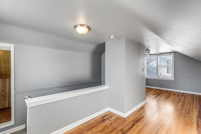 additional living space featuring ceiling fan, hardwood / wood-style floors, and vaulted ceiling