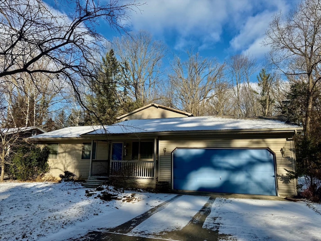 ranch-style house with covered porch and a garage