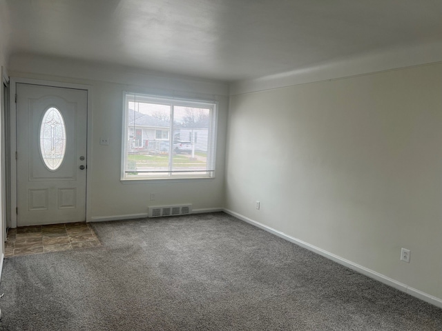 foyer entrance featuring carpet