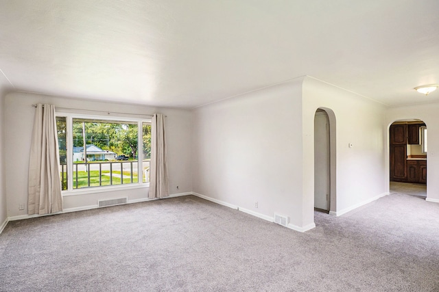 3085 S Center Rd, Burton, MI 48519 - unfurnished room with arched walkways and carpet floors
