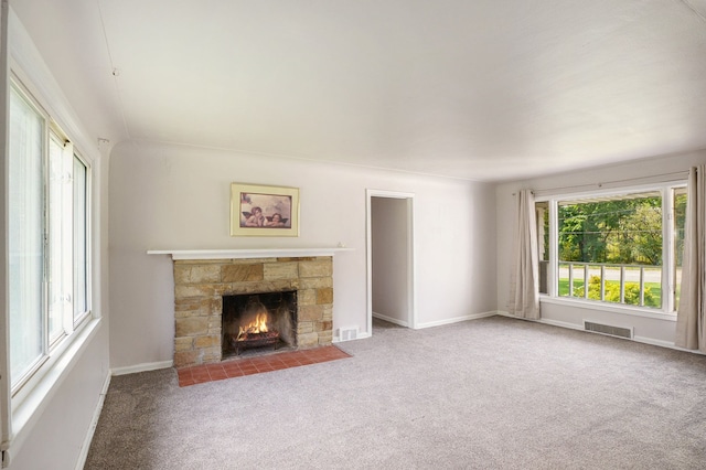 unfurnished living room featuring a fireplace and carpet