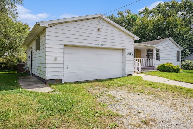 view of front of property with a garage, covered porch, and a front yard