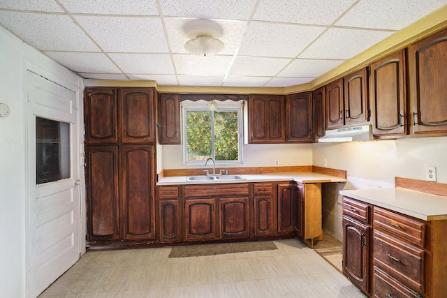 3085 S Center Rd, Burton, MI 48519 - kitchen with a paneled ceiling, under cabinet range hood, light floors, and light countertops