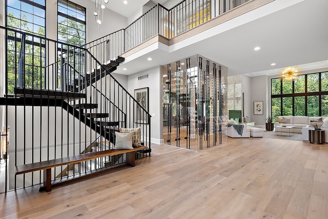 stairway featuring a high ceiling and hardwood / wood-style flooring