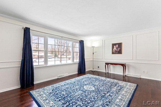 sitting room with dark hardwood / wood-style flooring and ornamental molding