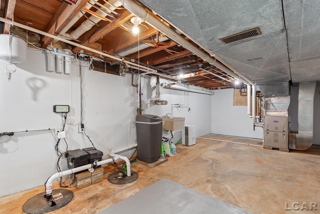 basement with heating unit and sink