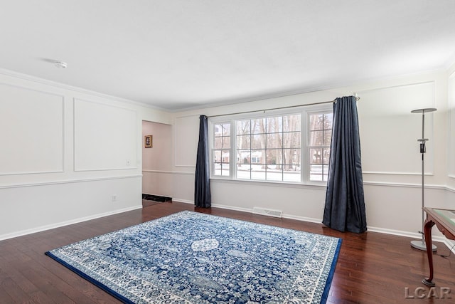 bedroom featuring crown molding and dark hardwood / wood-style floors