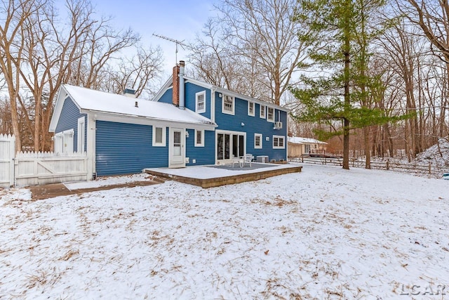 view of snow covered rear of property