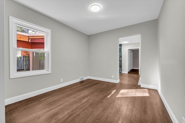 spare room with hardwood / wood-style floors