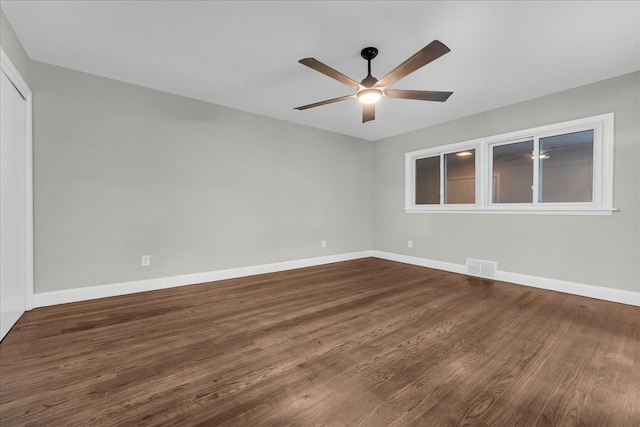 unfurnished room with dark hardwood / wood-style floors and ceiling fan