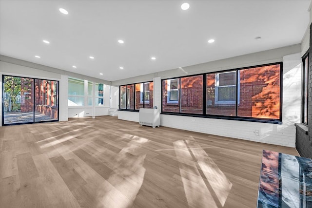 unfurnished living room with light wood-type flooring