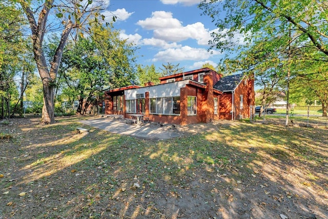 exterior space featuring a lawn and a patio area