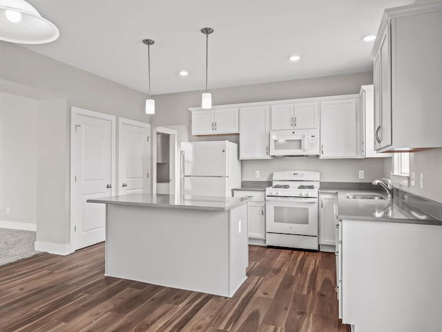 kitchen featuring white appliances, a center island, white cabinetry, and dark hardwood / wood-style floors