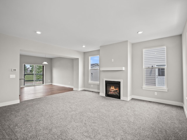 unfurnished living room featuring carpet flooring