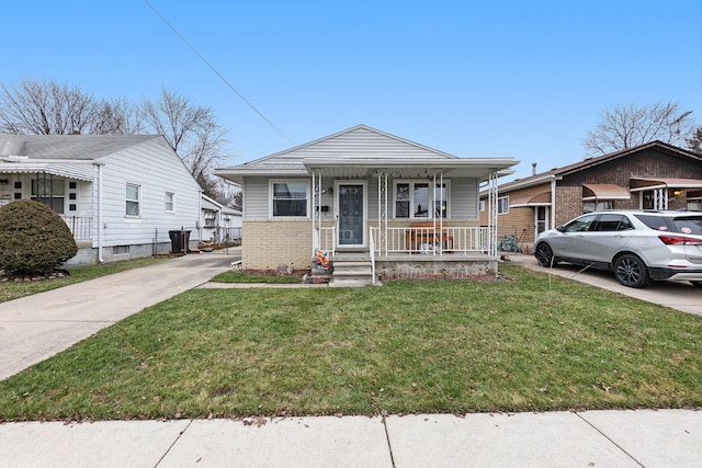 bungalow with a porch and a front lawn