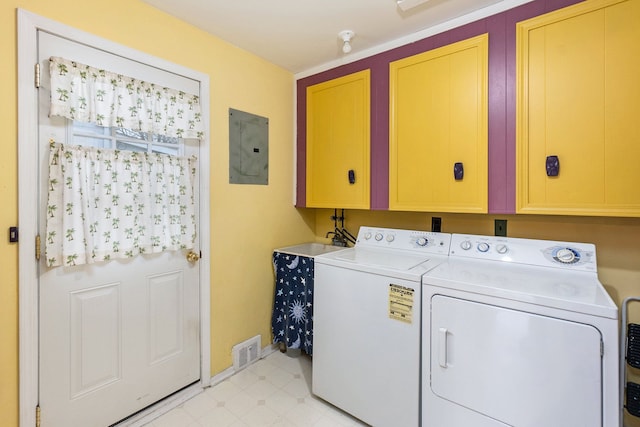 laundry room with cabinets, electric panel, and washer and clothes dryer