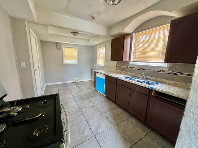 kitchen featuring sink, electric range oven, dishwasher, decorative backsplash, and a tray ceiling