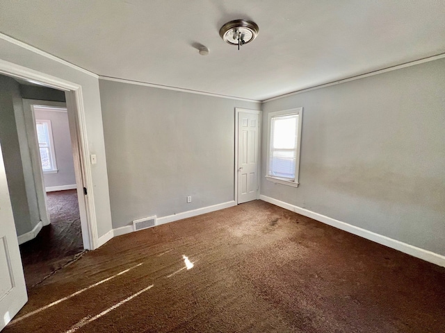 carpeted spare room featuring ornamental molding