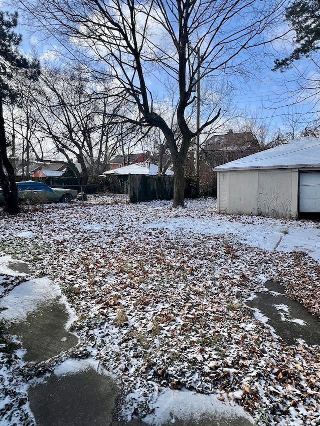 yard layered in snow featuring an outdoor structure