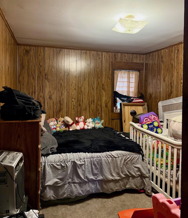 carpeted bedroom featuring wooden walls