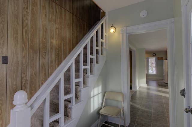 staircase with wooden walls