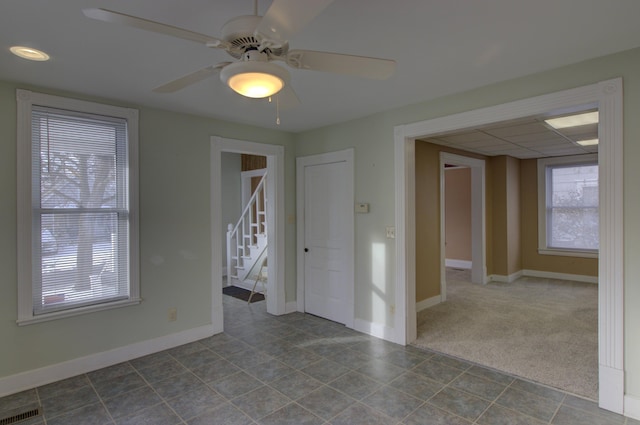 spare room with ceiling fan and carpet floors