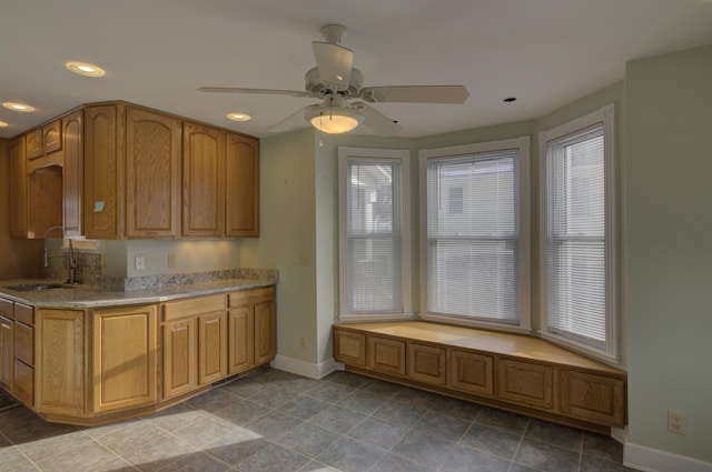 kitchen with tile patterned flooring, ceiling fan, and sink