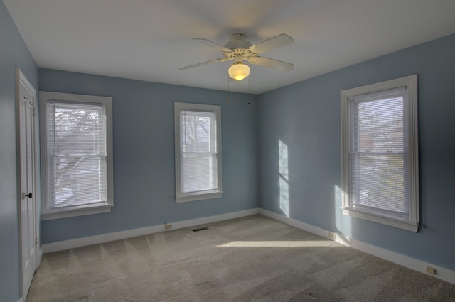 spare room with light carpet and ceiling fan