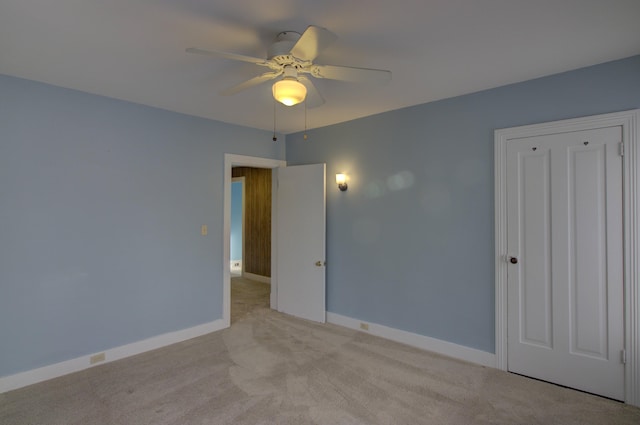 unfurnished bedroom featuring ceiling fan and light carpet