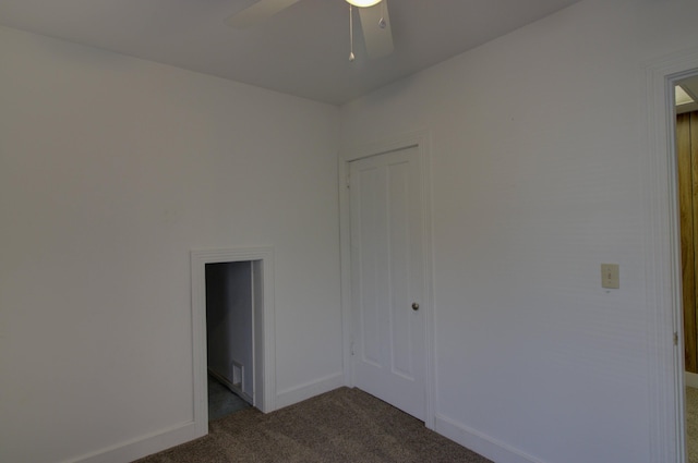 carpeted spare room with ceiling fan