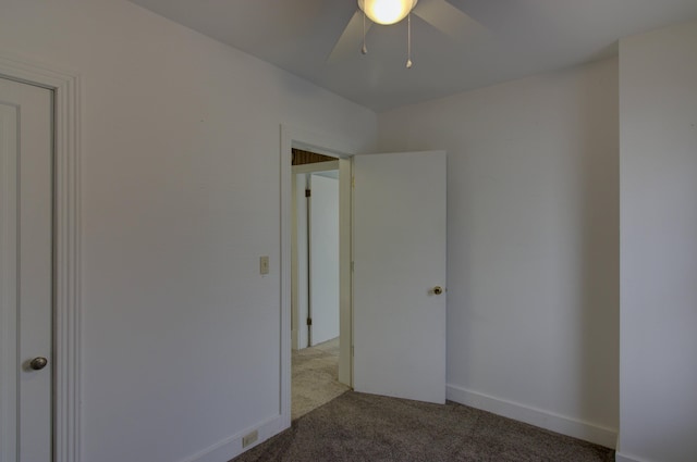 carpeted empty room featuring ceiling fan