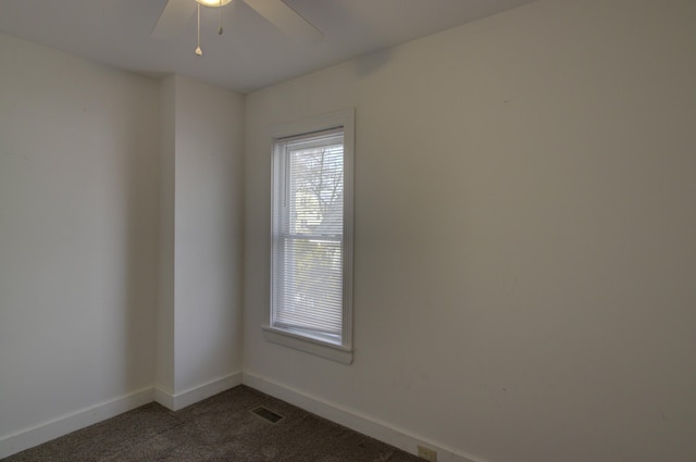 carpeted spare room with ceiling fan