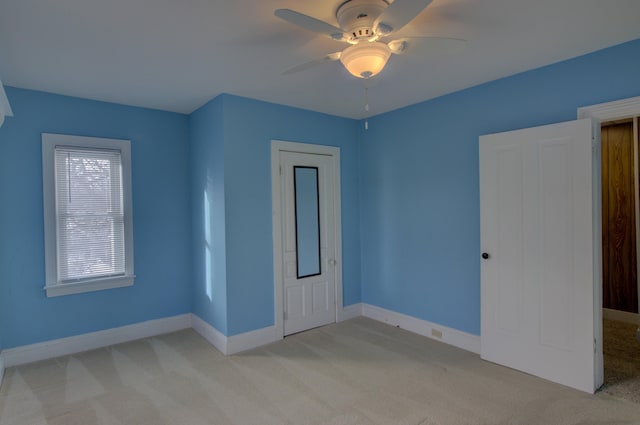 interior space featuring light colored carpet and ceiling fan